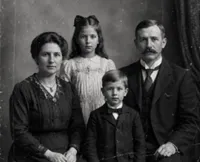 Damaged vintage family portrait photo used as a photo restoration sample