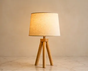 Wooden tripod table lamp against a plain wall, used as a background removal sample